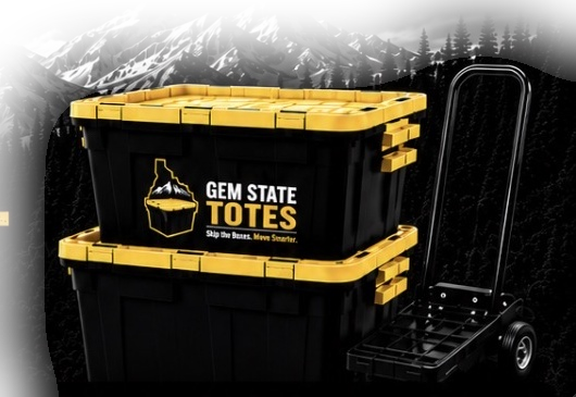 Stacked black and yellow moving totes with a dolly